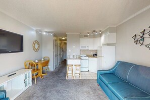 A compact living space with a kitchenette, a dining area, and a seating area. - Casa Del Mar - The Seaside (Galveston)