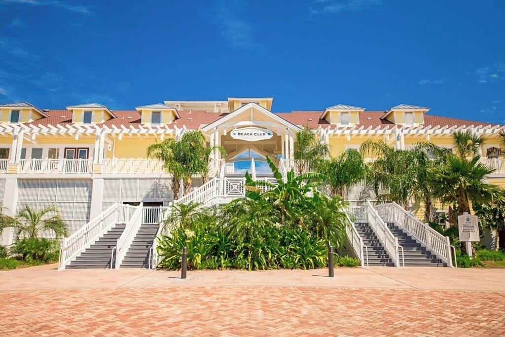 A hotel with a central entrance, multiple staircases, and a covered area.