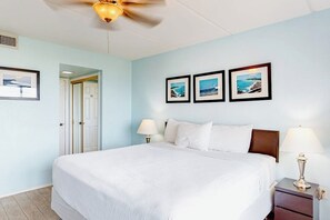 A hotel room with a large bed, two bedside tables with lamps, a ceiling fan, and framed pictures on the wall. - Continental #201 - Gulf-Front with Beach Access (South Padre Island)