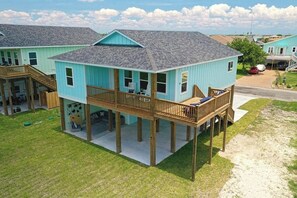 A two-story house with a balcony, a deck, and a covered outdoor seating area. - LandsEnd - Indoor-Outdoor Living, Boat Parking (Rockport)