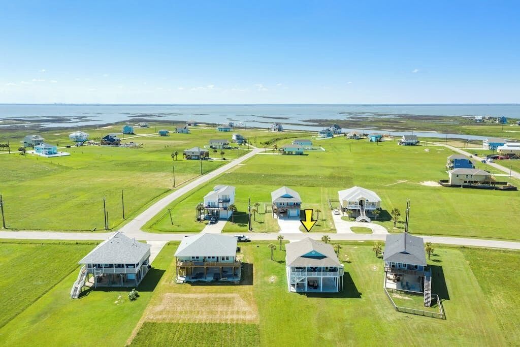 A residential area with multiple houses, some with attached garages, and a clear view of the surrounding landscape.