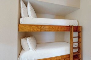 A bunk bed with a wooden ladder and white bedding. - Suntide II Condominiums #101 (South Padre Island)