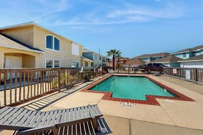 A swimming pool with a no diving sign, surrounded by a wooden deck and a fence. - Village Townhomes on the Greens Unit 106 (Corpus Christi)