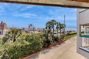 A coastal view with palm trees and a clear sky. - Casa Del Mar - Mi Casa 113 (Galveston)