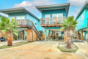 A beachfront property with two-story buildings, wooden balconies, and palm trees. - Stack Overflow - Balcony, Pool & Dog-Friendly (Port Aransas)