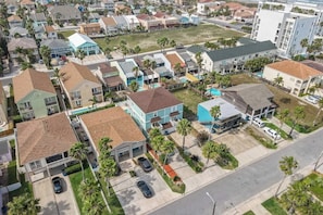 A residential area with houses, a swimming pool, and a gas station. - Island Escape Unit B (South Padre Island)