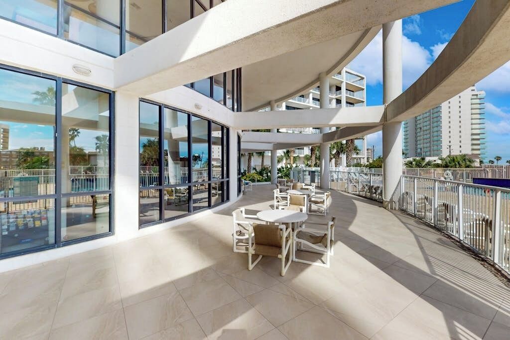 A spacious outdoor area with a seating arrangement and a view of the cityscape.