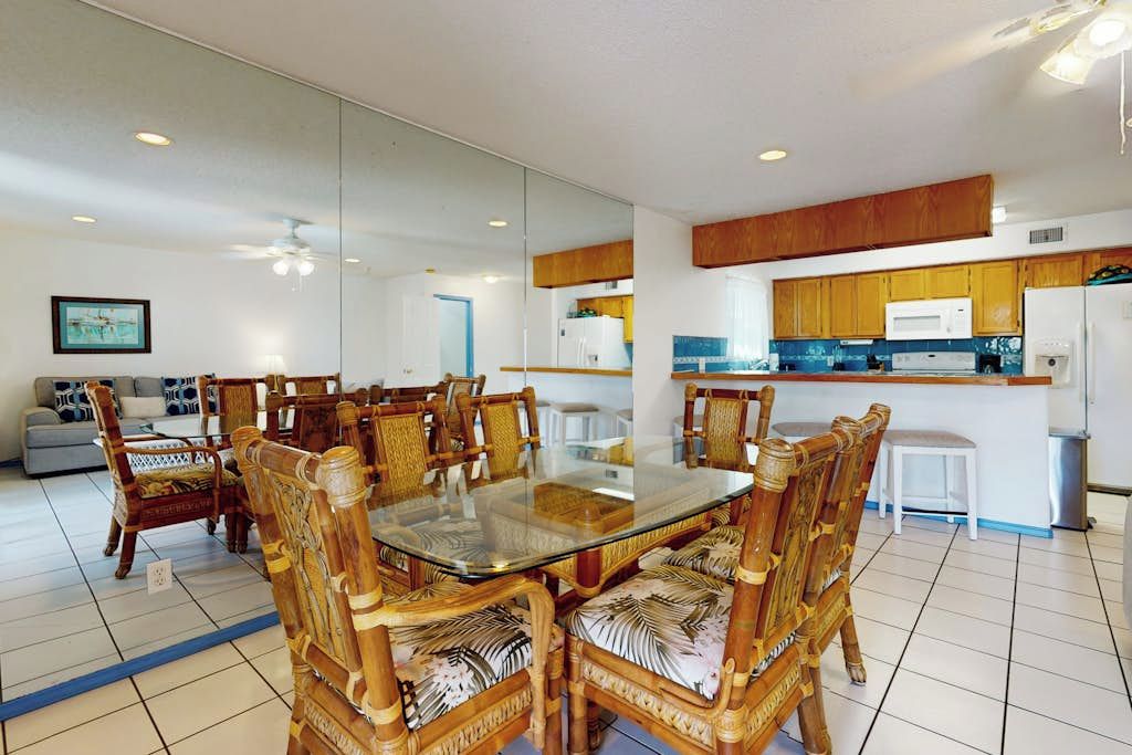 A modern kitchen with wooden cabinets and a built-in microwave.
