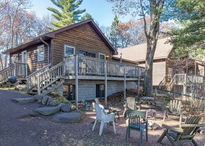 A cabin with a deck, outdoor seating, and a barbecue grill. - Pinewood Cabin, Resort, Lake, Beach, Kayaks & More (Lac du Flambeau)