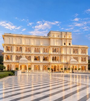 A multi-story building with a large open courtyard, featuring a series of balconies and arched windows.