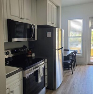 A kitchen with a stove, oven, microwave, and refrigerator. - Cozy 1 bedroom unit on 30 A children friendly (Santa Rosa Beach)