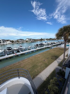 A marina with boats docked, a grassy area, and a clear sky. - Spacious 3-bedroom condo in charming Tierra Verde on the Grand Canal (Tierra Verde)