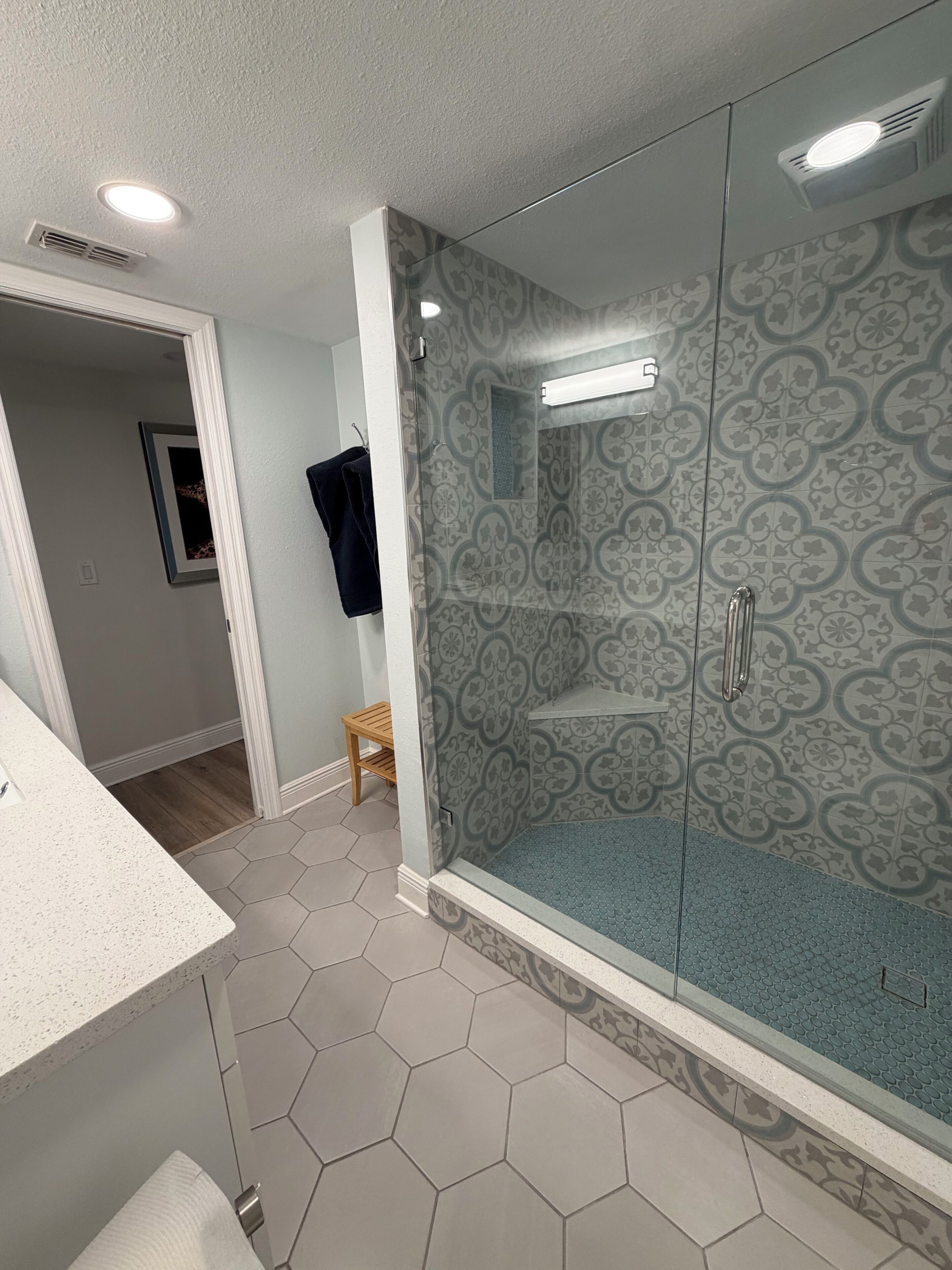 A bathroom with a shower, a toilet, and a sink.