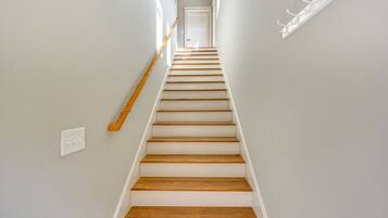 A staircase with wooden steps and white walls.