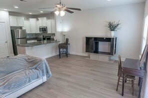 A modern kitchen with white cabinets, a microwave, and a stainless steel refrigerator. - Pet-Friendly Lake Views from Most Rooms, Townhome, Walk to Beach & (Panama City)