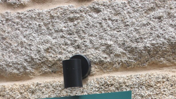 A teal sign with a star and compass design, mounted on a stone wall. - Vrbo Property (Tui)