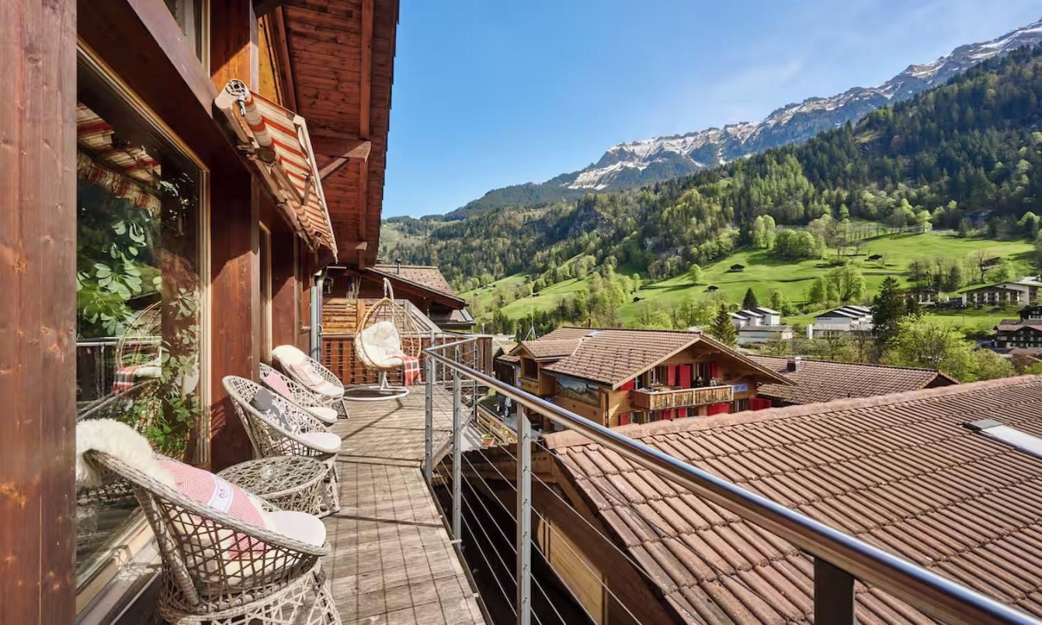 A wooden building with a balcony overlooking a mountainous landscape.