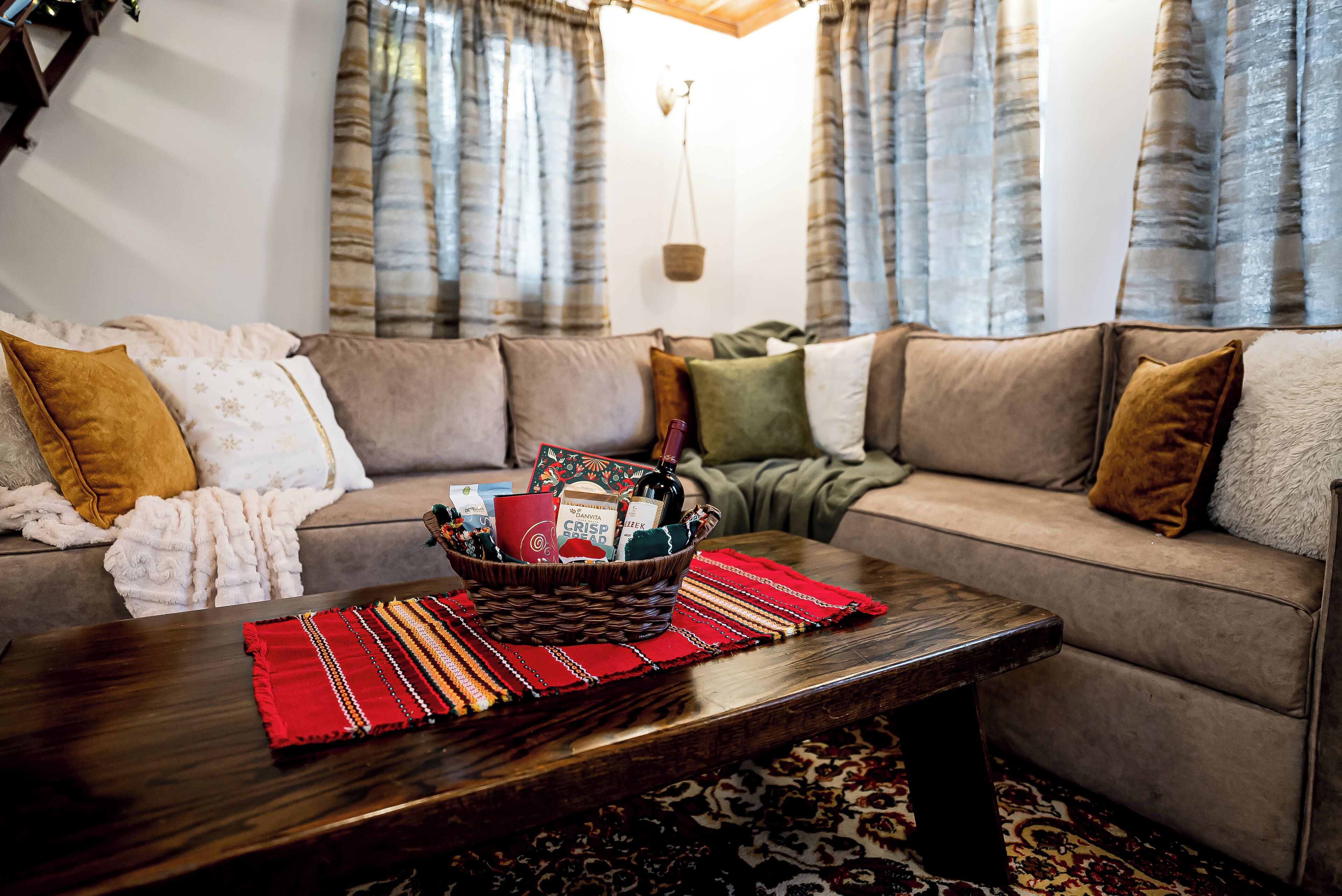 A living room with a sofa set, a coffee table, and a basket of items.