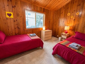 A room with two beds, a window, a dresser, and a lamp. - Sunshine Daydream /Town Center/RV Parking/AC/River (Kernville)