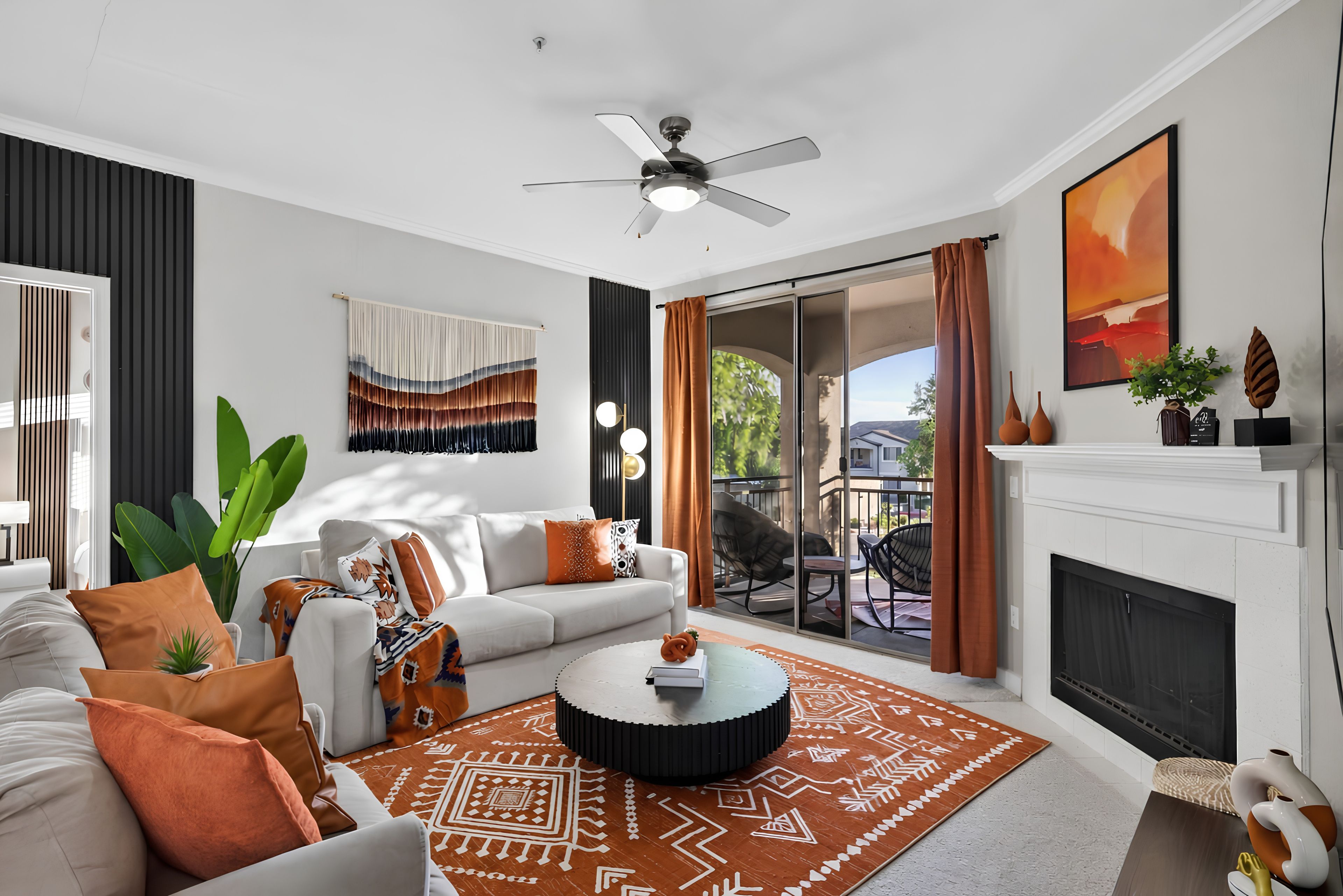 A modern living room with a sofa, coffee table, and a fireplace.