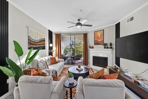 A modern living room with a sofa set, a coffee table, and a fireplace.