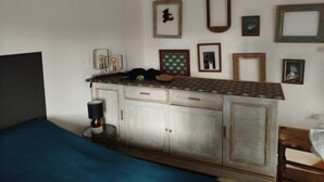 Un dormitorio con cama, cómoda y luces en la pared.