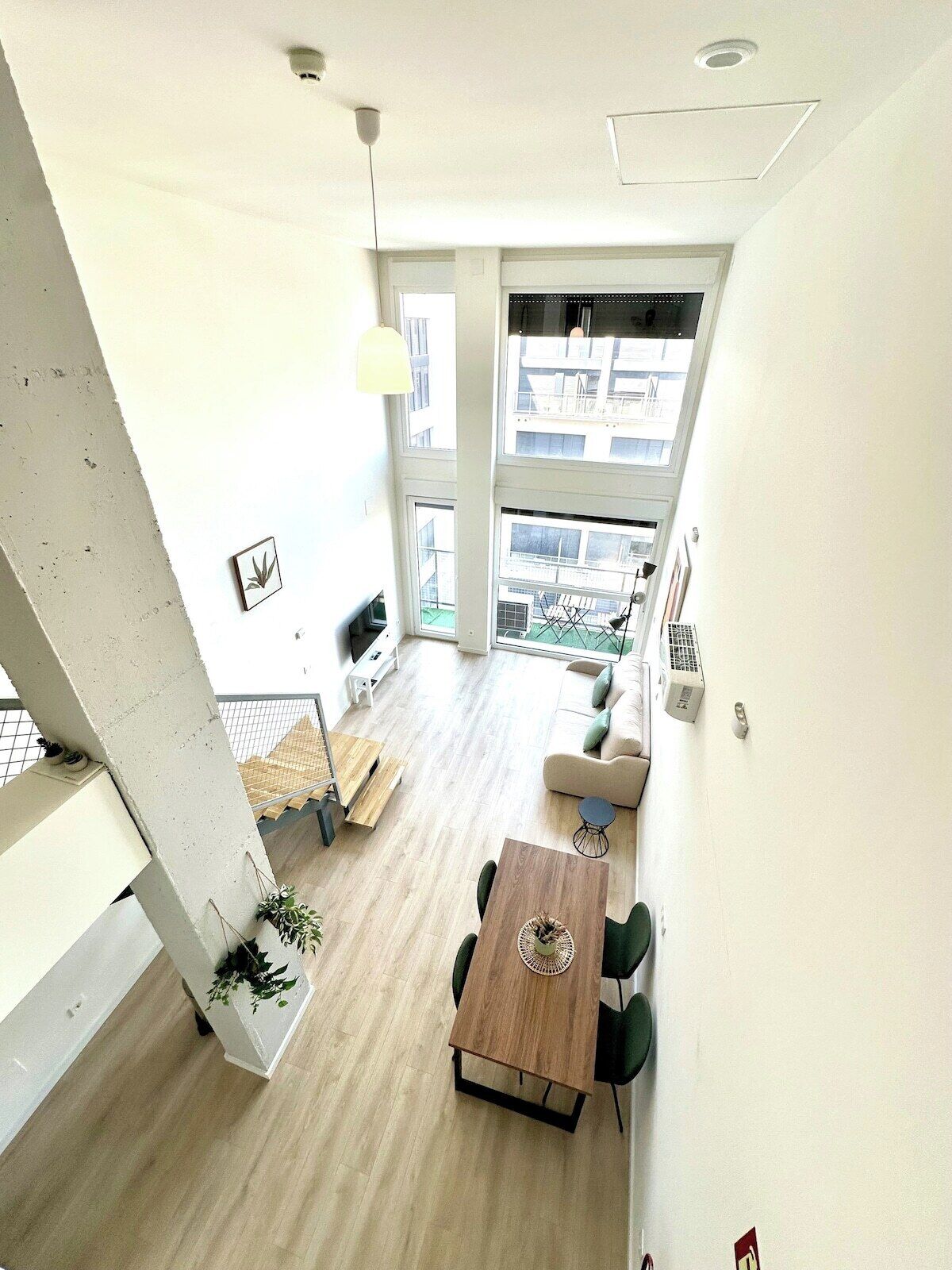 Un intérieur moderne comprenant un coin repas, un escalier et une vue sur l’extérieur.