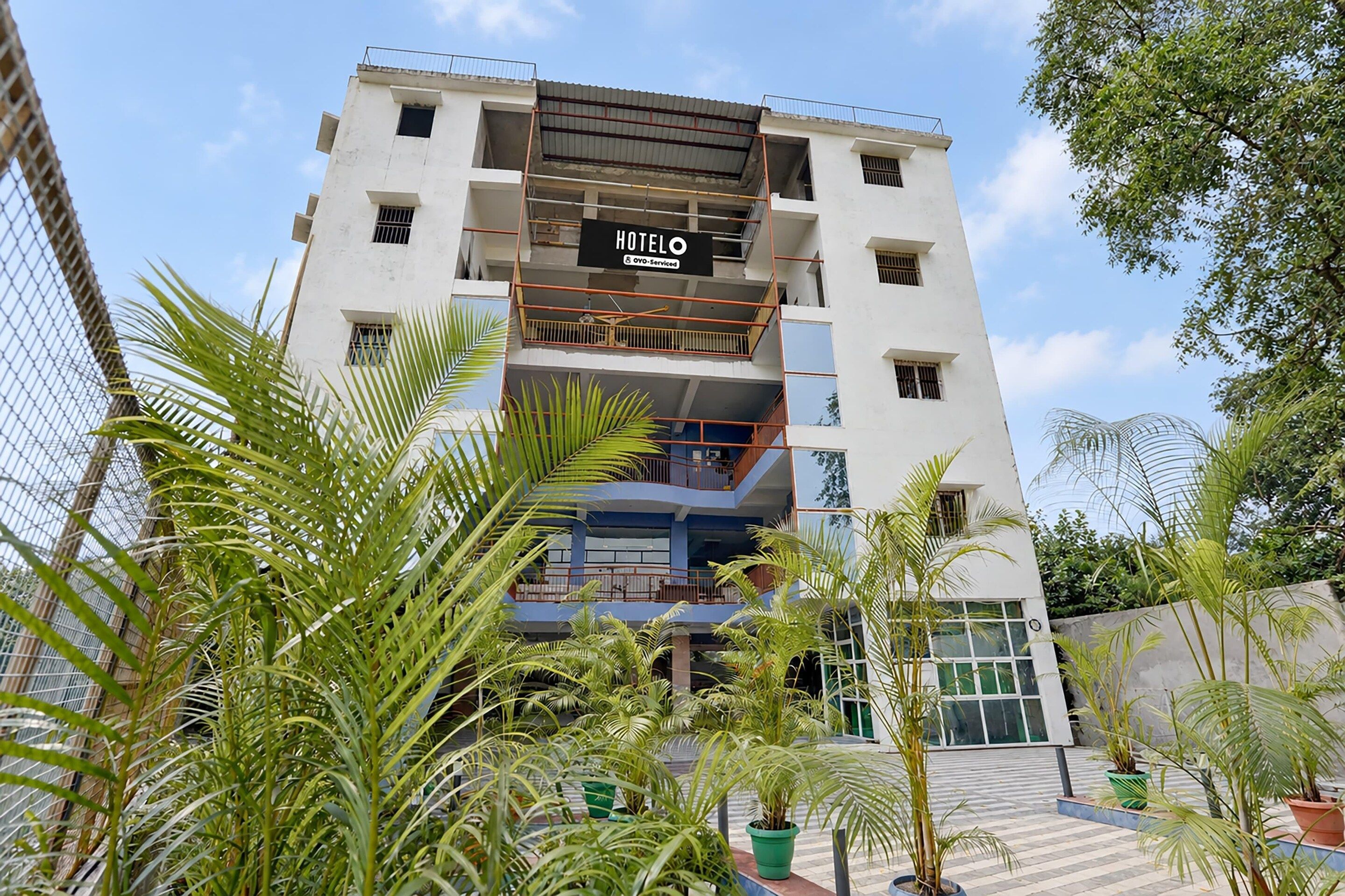 A multi-story hotel with a sign indicating it is a hotel and a service company.