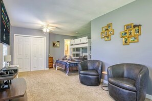A bedroom with a bunk bed, a desk with a computer, a chair, and a ceiling fan. - Sleepy Cub Hollow! Dollywood | Fenced In | Hot Tub (Sevierville)