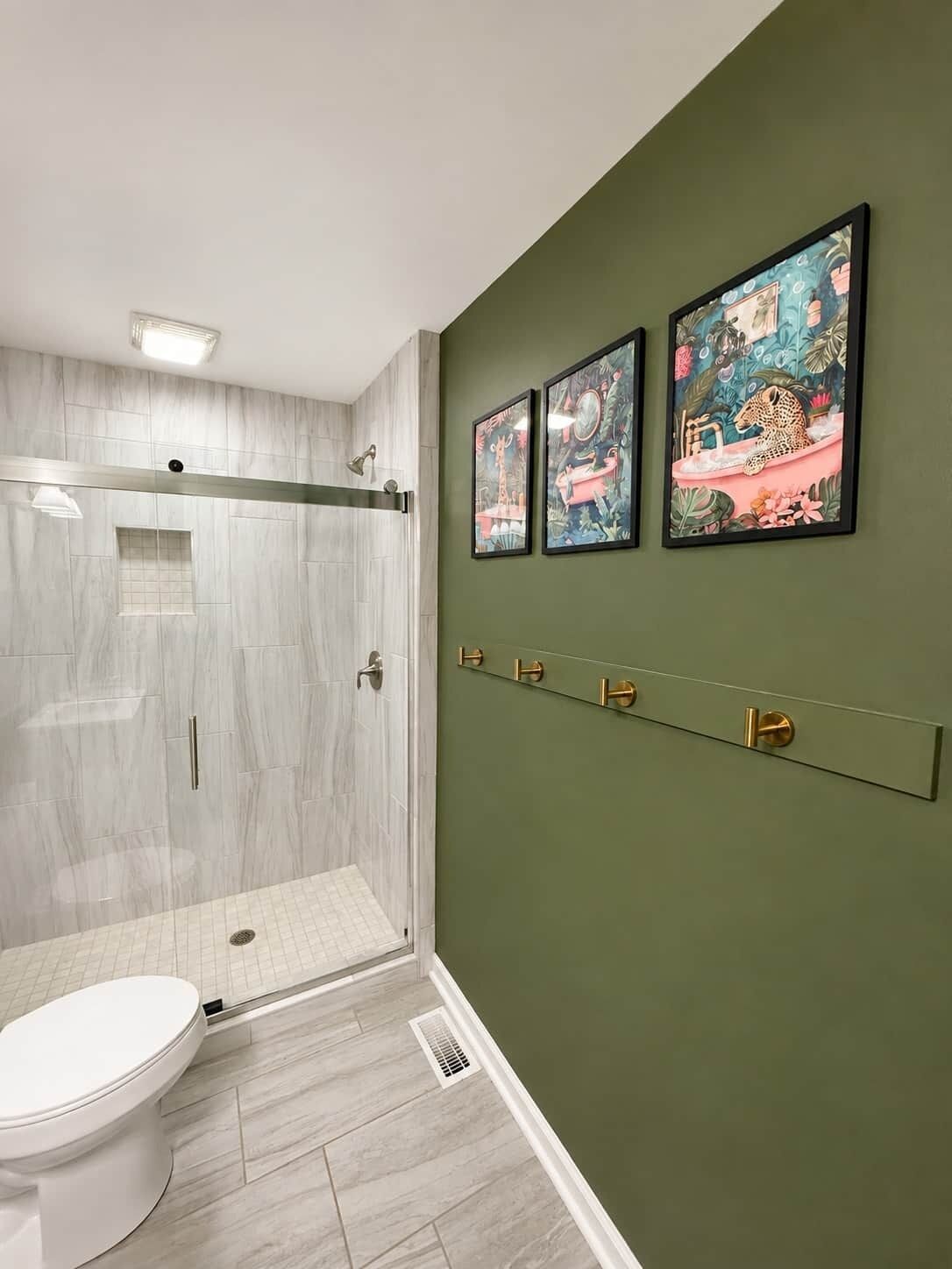 A bathroom with a walk-in shower, a toilet, and a wall-mounted sink.