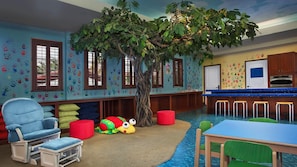 A children's playroom with a large artificial tree, colorful handprints on the walls, a small pool, and a kitchen area. - 2BR Villa at Marriott's Lakeshore Reserve Near Disney & Orlando Attractions (Orlando)