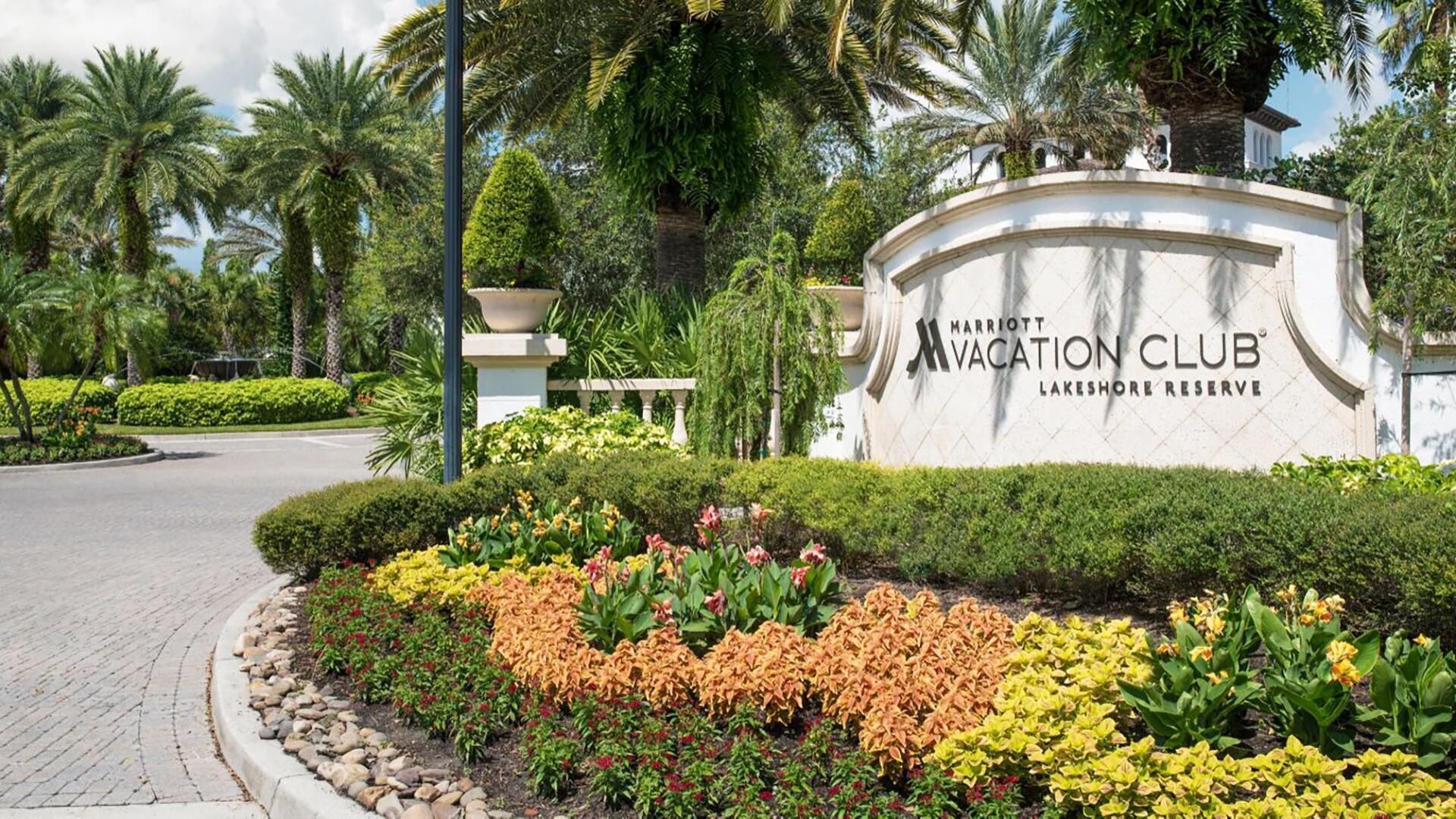 A landscaped area with a sign for the Marriott Vacation Club Lakeshore Reserve.