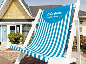 A striped beach chair in front of a caravan sales office. - Cala Gran Holiday Park - Holiday Accommodation 20111 (Fleetwood)