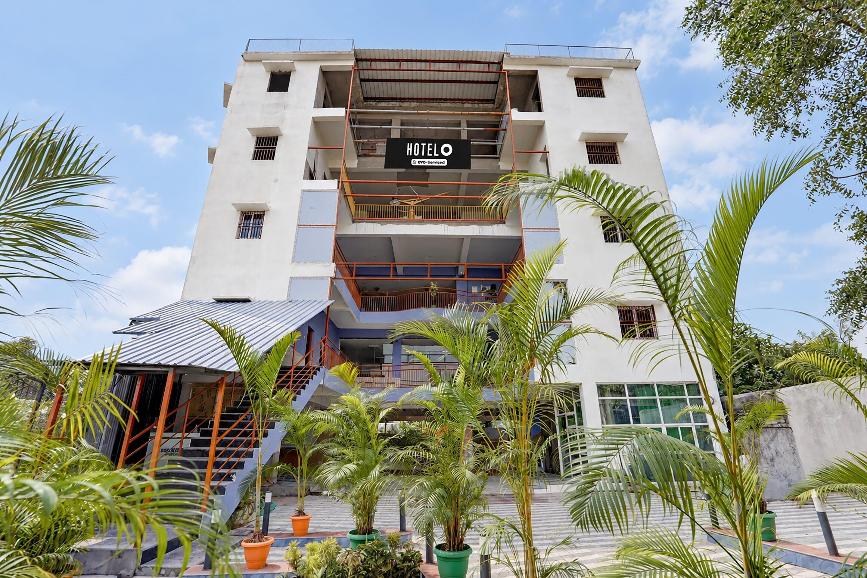 A multi-story hotel with a sign reading 'HOTEL' and balconies on each floor.