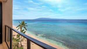 A balcony with a clear view of a beach and ocean. - 2 Villas, Oceanfront, 3 Bedrooms, Sleeps 6 (Kaanapali)