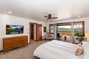 A bedroom with a bed, a dresser, a chair, a ceiling fan, and a balcony with a view. - Eagles Peak. Lake Arrowhead Modern Lake View Lodge. Pool Table AC Panorama Views (Lake Arrowhead)