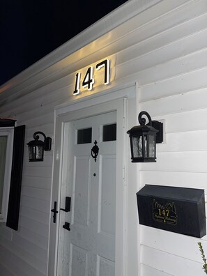 A white building with the number 147 displayed above the door.