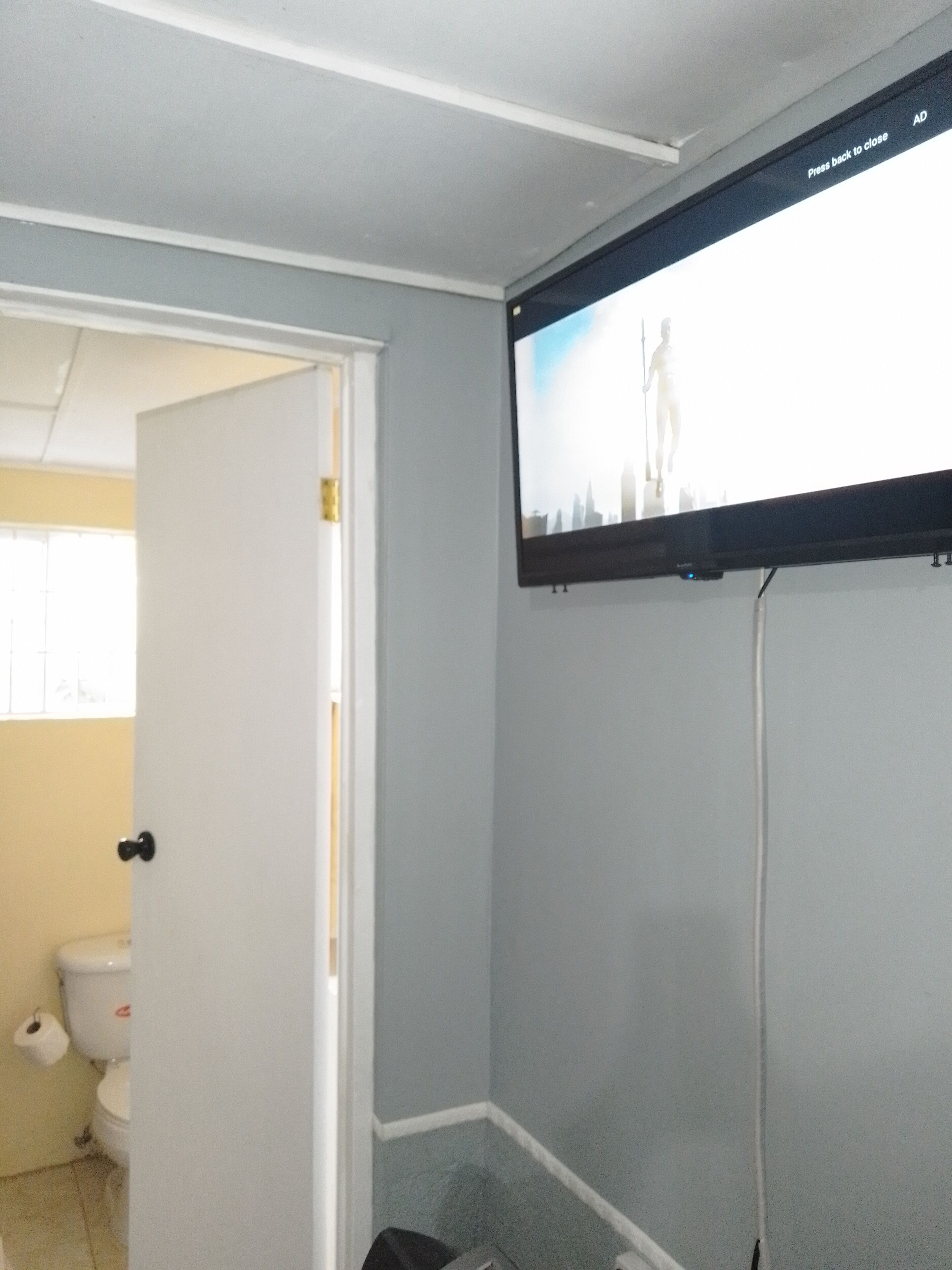 A bathroom with a toilet, a shower, and a sink.