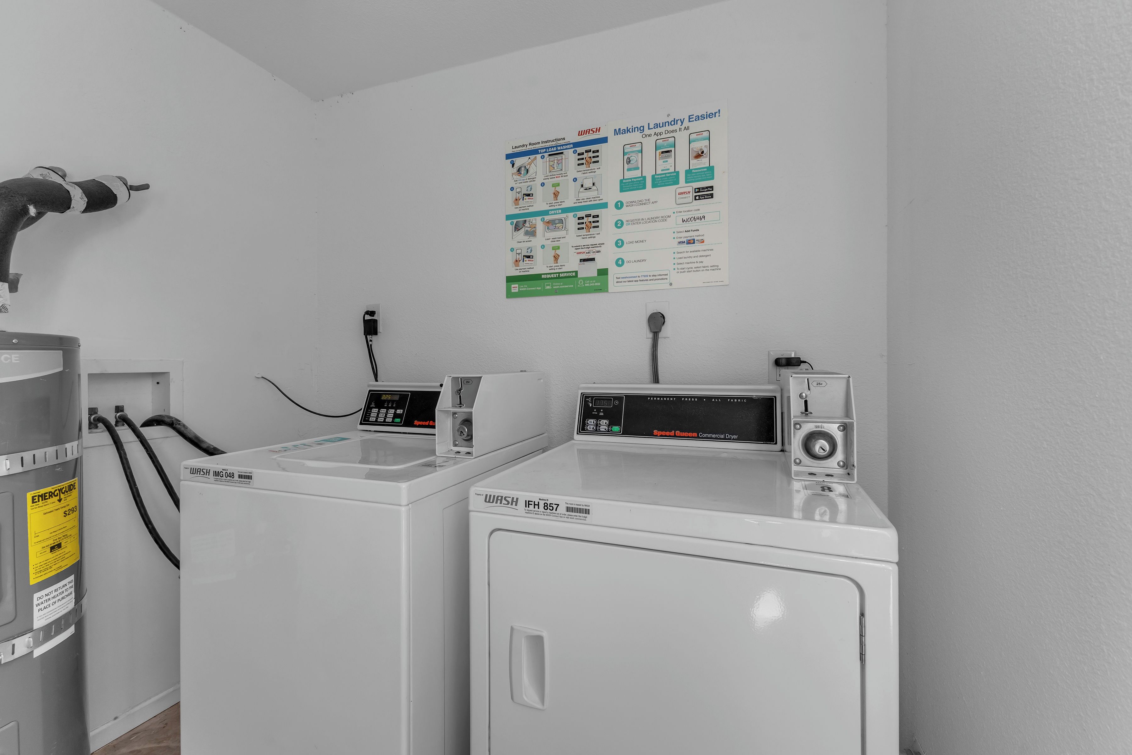 A laundry facility with two washers and dryers, a water heater, and a poster with laundry instructions.