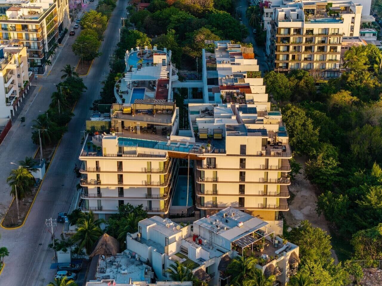 A multi-story hotel with balconies, a swimming pool, and a central courtyard.