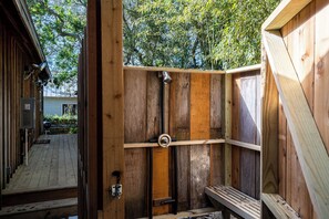 A wooden outdoor shower enclosure with a door, a bench, and a hose. - Walk to Beach & Grayton Beach- Artless Sprite by Royal Destinations (Santa Rosa Beach)