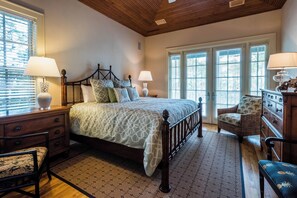 A bedroom with a wooden bed, a nightstand, a chair, a dresser, and a window with blinds. - WaterColor Lake Views & Resort Amenities- Far Niente by Royal Destinations (Santa Rosa Beach)