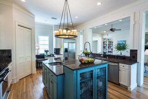 A modern kitchen with a central island, a dining area, and a living space. - WaterColor Lake Views & Resort Amenities- Far Niente by Royal Destinations (Santa Rosa Beach)
