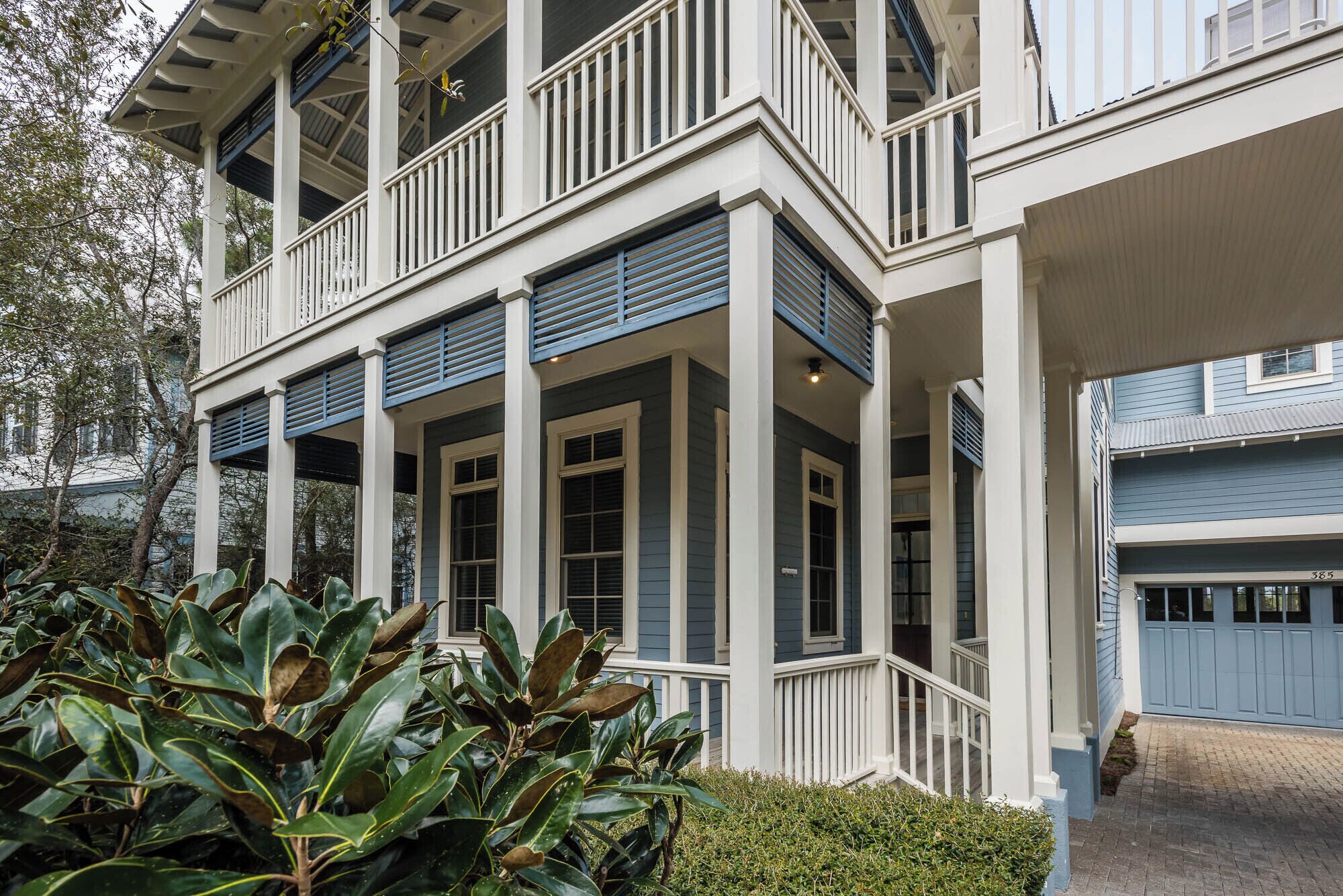 A two-story house with a covered porch and a garage.