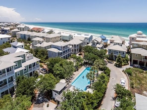 A coastal residential area with multiple two-story houses, a swimming pool, and a view of the ocean. - 2 Community Pools, Walk to Beach- Follow the Heron by Royal Destinations (Santa Rosa Beach)