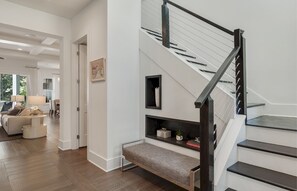 A modern interior with a staircase, a bench, and a dining area. - Private Pool, Walk to Grayton Beach- Grayton Pointe by Royal Destinations (Santa Rosa Beach)