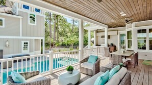A covered outdoor area with a pool, wicker furniture, and a kitchen area. - Private Pool, Walk to Grayton Beach- Grayton Pointe by Royal Destinations (Santa Rosa Beach)