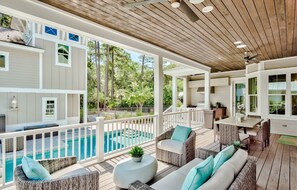 A covered outdoor area with a pool, wicker furniture, and a kitchen area. - Private Pool, Walk to Grayton Beach- Grayton Pointe by Royal Destinations (Santa Rosa Beach)