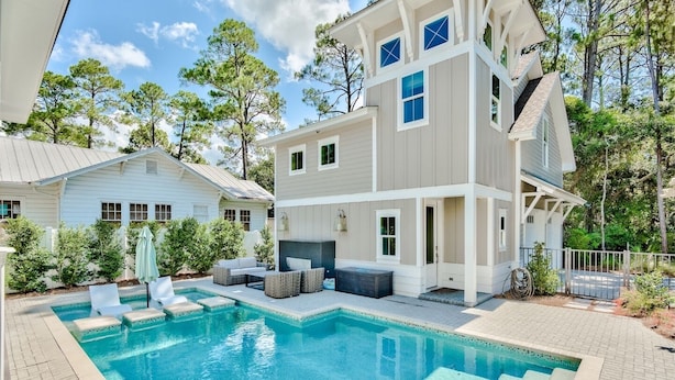 A two-story house with a swimming pool, outdoor seating, and a fenced yard. - Private Pool, Walk to Grayton Beach- Grayton Pointe by Royal Destinations (Santa Rosa Beach)