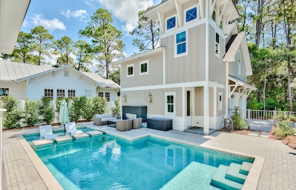 A two-story house with a swimming pool, outdoor seating, and a fenced yard. - Private Pool, Walk to Grayton Beach- Grayton Pointe by Royal Destinations (Santa Rosa Beach)